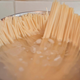 Pasta boiling in bot, uncooked ends sticking up out of the water